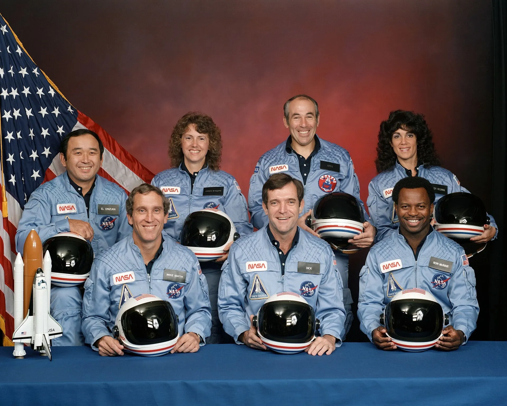 The crew of Challenger's final flight, STS-51-L. Seventy-three seconds after launch on a cold January morning in 1986, a stiffened booster seal failed and the vehicle broke apart. All seven died — and the investigation found the risk had been known and normalised.
