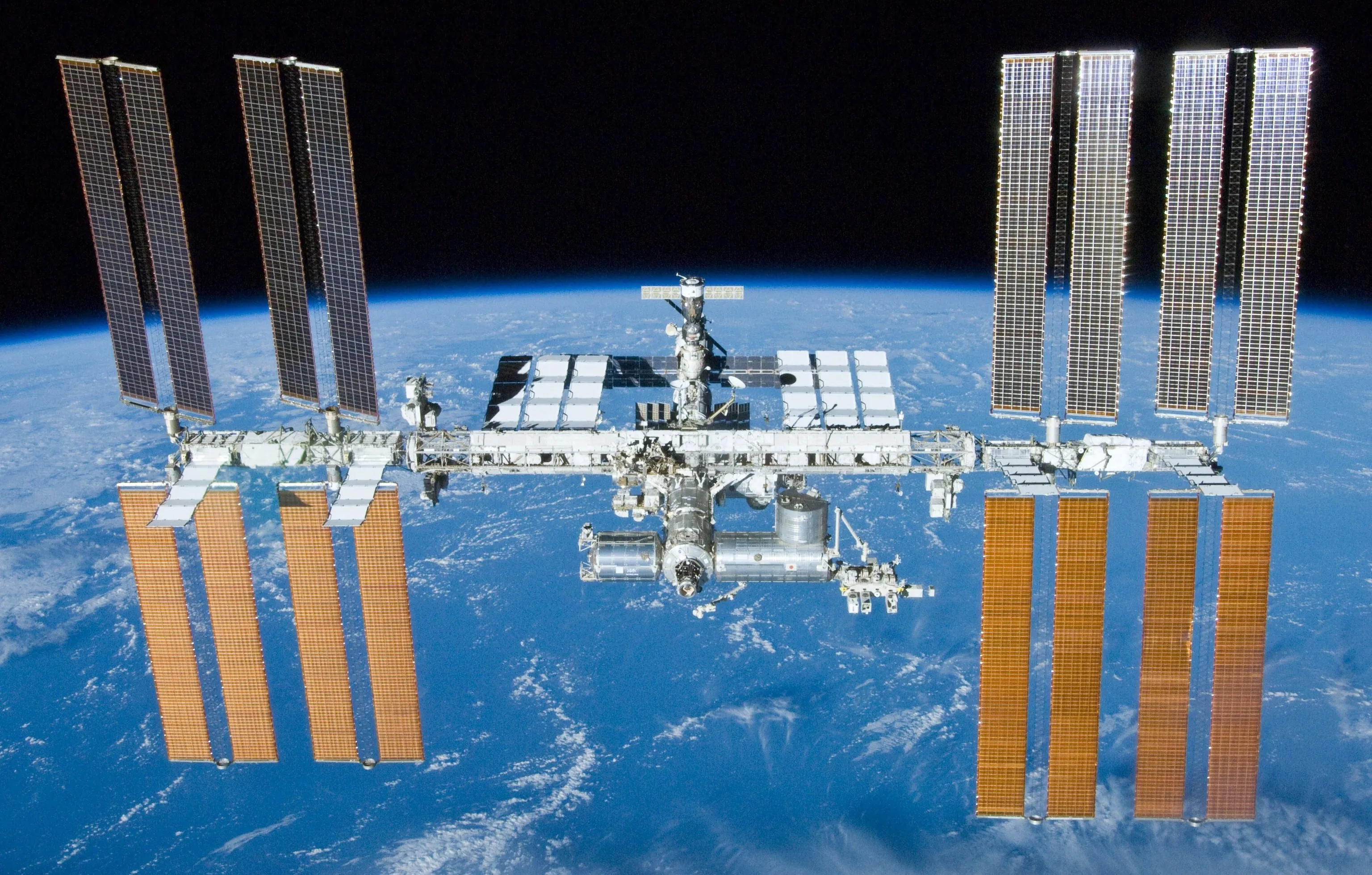 The Station against the Earth. Its deepest achievement is not its size or its science but its continuity — an unbroken human presence in space, sustained by international cooperation, for over two decades.
