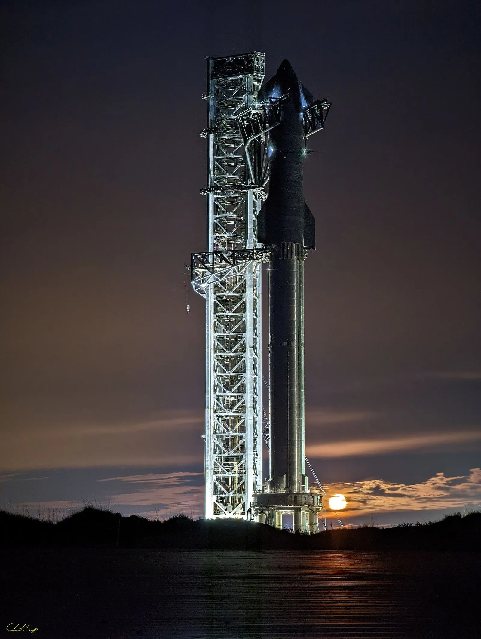 A Starship test flight. The program's method is visible failure at scale: fly, watch it break, learn, fly again — the same iteration that made Falcon cheap, applied to the largest rocket ever built.