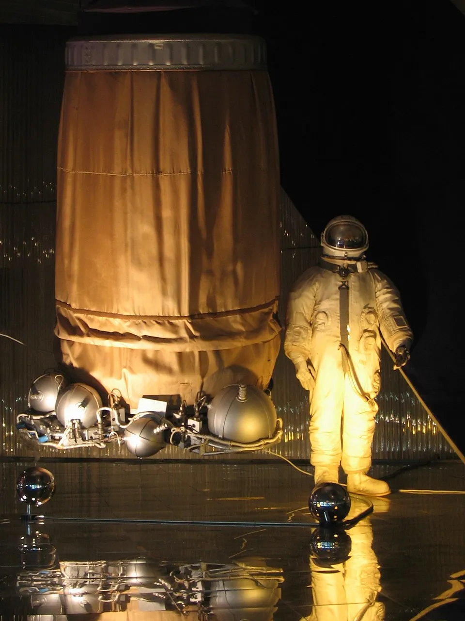 Voskhod — a Vostok stripped of its ejection seat and repacked to carry more crew. The room for three came at the cost of the escape system and, on the first flight, of pressure suits.